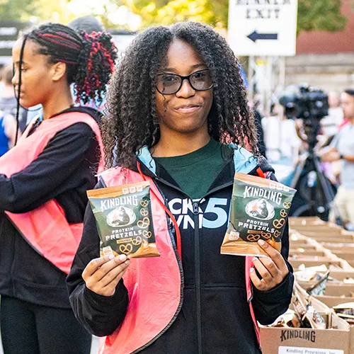 volunteer holding snacks